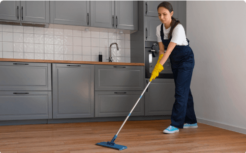 Cleaner mopping a kitchen floor during a house deep cleaning service in Belfast